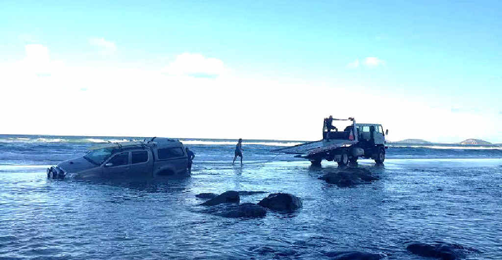 STUCK: The driver of this Toyota Hilux dual cab was winched off the Mudlo Rocks on Sunday afternoon in the first recovery mission at the infamous beach obstacle this year. STUCK: The driver of this Toyota Hilux dual cab was winched off the Mudlo Rocks on Sunday afternoon in the first recovery mission at the infamous beach obstacle this year.